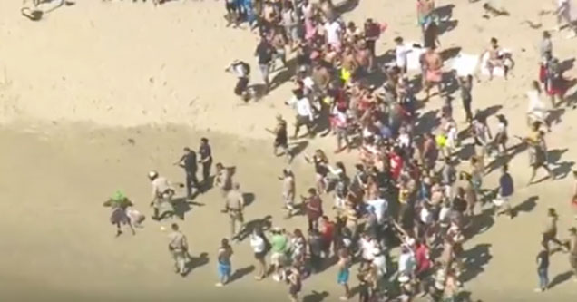 Bizarre Police Chase Ends With Man Dressed As Joker Stopping To Help Bury Someone in the Sand