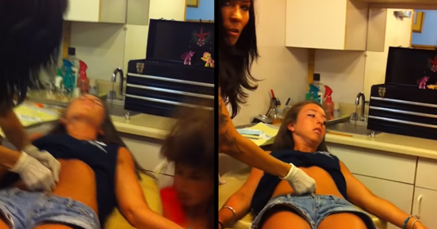 a girl getting her belly button pierced and her friend passing out