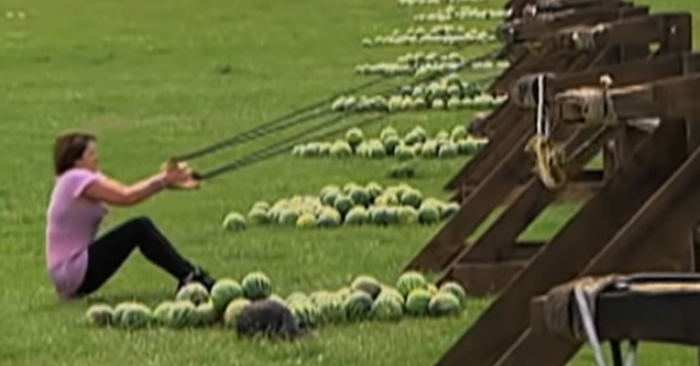 a woman shooting watermelons with a slingshot