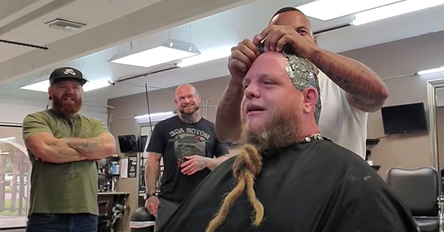 a man having his whole head waxed in a barber shop