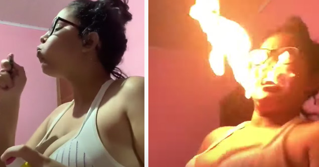 a girl blowing fire but setting her hair and face on fire