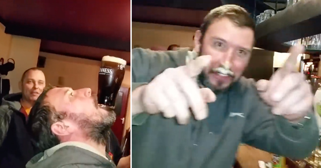 guy drinking a pint of guinness beer without touching the glass with his hands