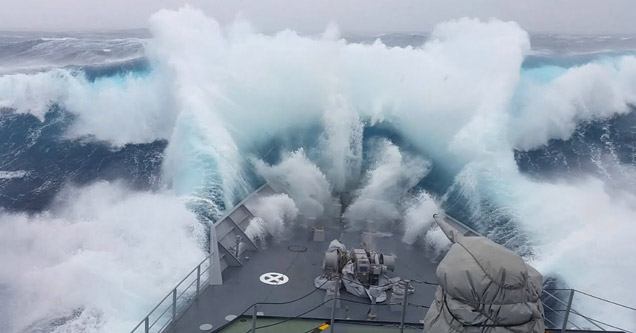 a massive wave hitting a warship in the Antarctic sea