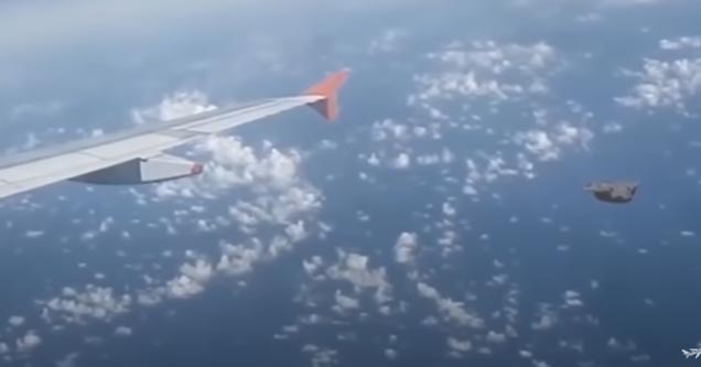 a ufo flying near an airplane