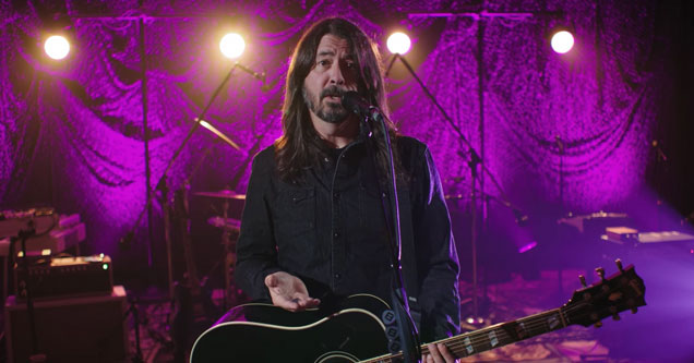 Dave Grohl holding a guitar and explaining how he came up with the foo fighters song everlong