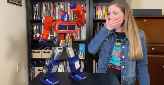 Reporter reacts to self-transforming Optimus Prime robot