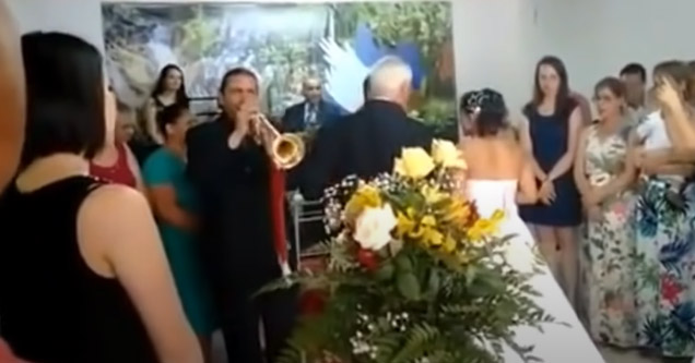 a guy playing the trumpet at a wedding