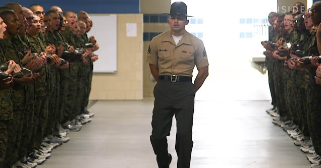 Drill instructor examines Marines