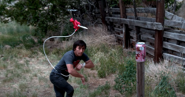 guy using a rope dart to cut in half a can of soda -  real life scorpion