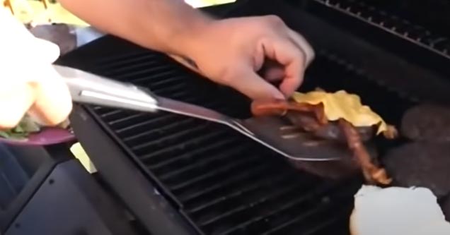 a man making bacon cheeseburgers on the grill