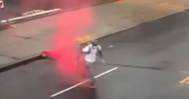 a bank robber with a red dye pack exploding