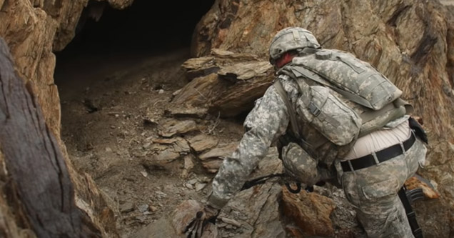 a marine looking into a cave