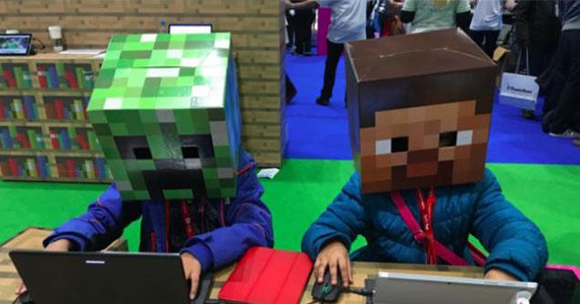 how Minecraft changed video games forever -  two guys sitting at a desk wearing pixelated Minecraft heads