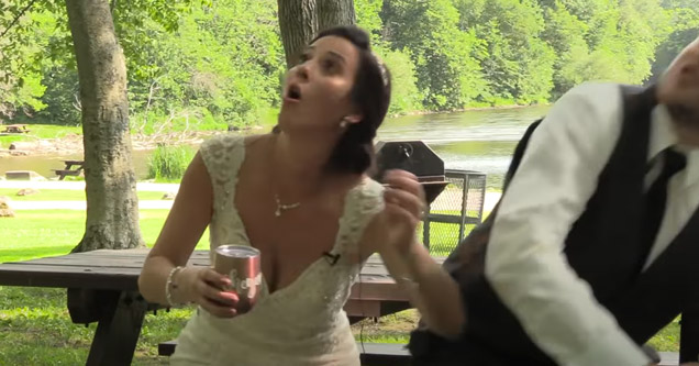 a bride and groom sitting on a bench when a large branch falls