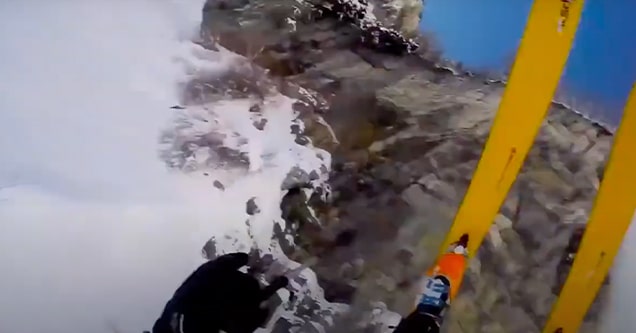 skiier falls into snow