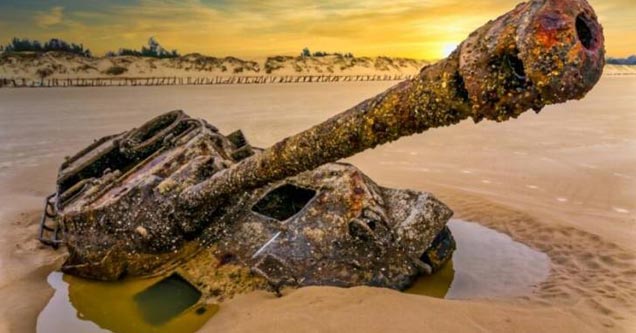 an old rusted tank on the beach