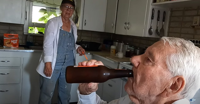 an old man chugging a beer