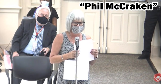 a woman with a mask on at a city meeting