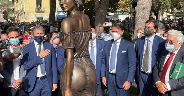 sexy italian statue in Italy with a group of men standing around