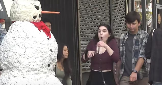 a fake snowman with a person inside scaring people