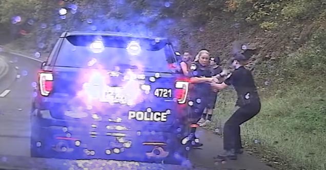 a cop pulling his partner away from an oncoming car crash