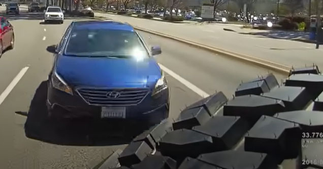 a blue car behind a jeep wrangler