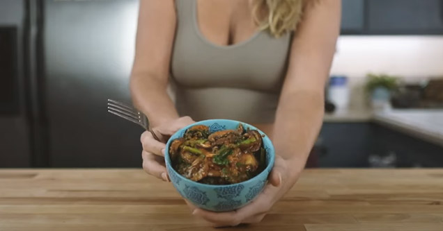 a busty blonde holding a bowl of food