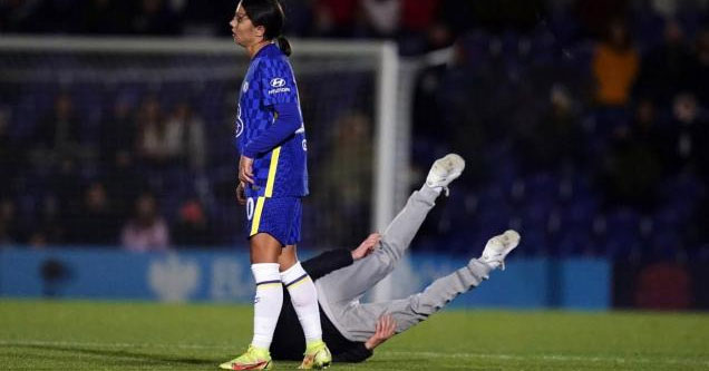 a fan getting knocked on his butt by sam kerr