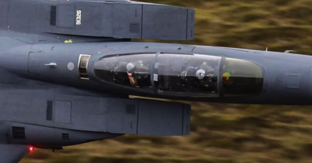 an F15 Eagle fighter jet doing low flyby