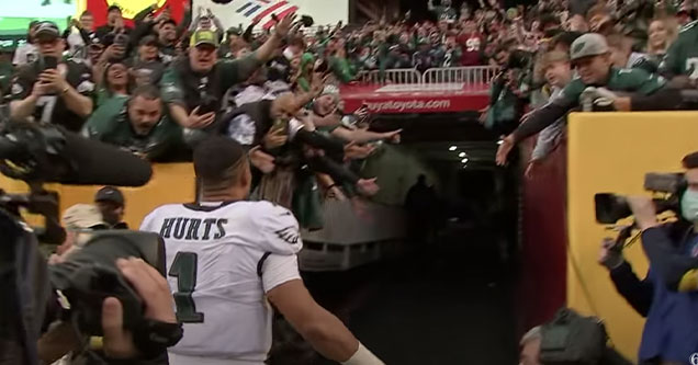 jalen hurts almost crushed by fans falling over railing