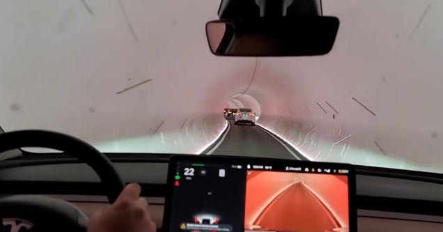 a tesla in a boring tunnel stuck in traffic