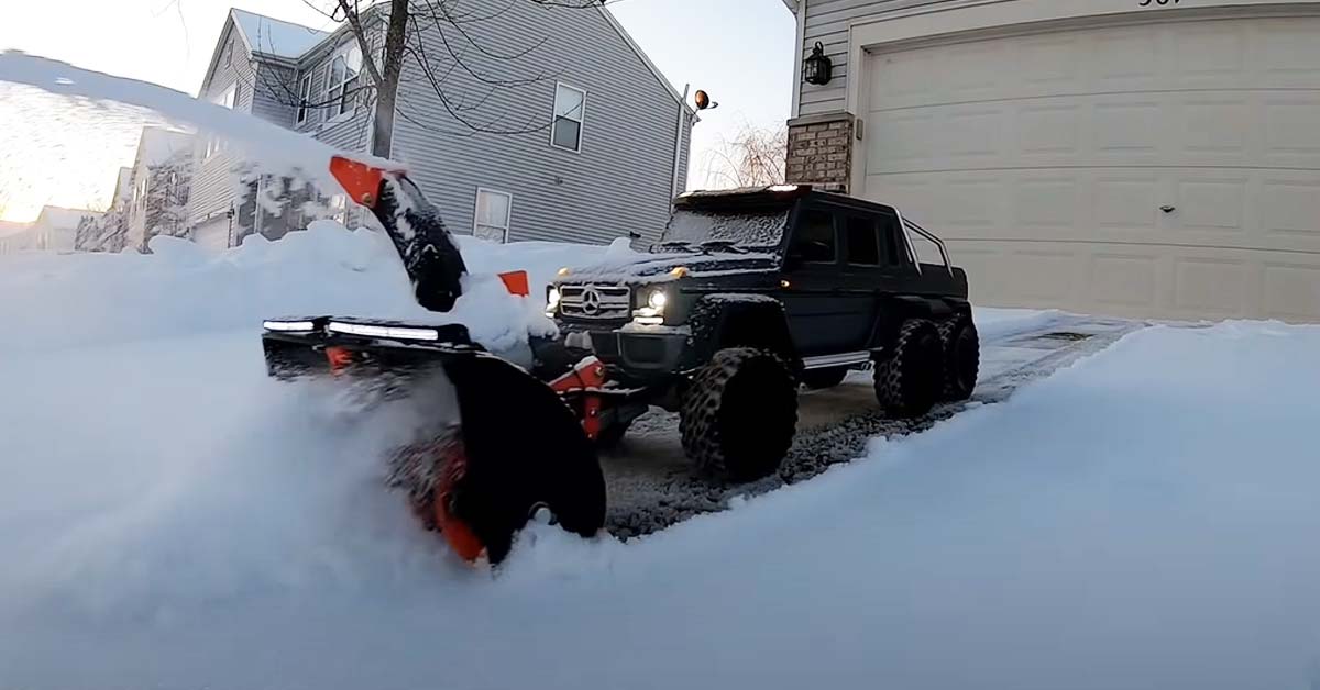 an rc truck with a snow plow and snowblower