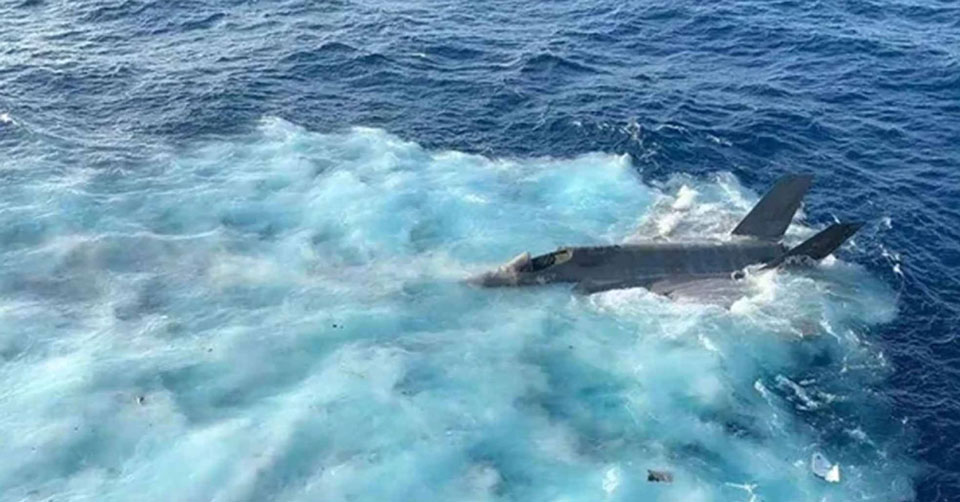 navy fighter jet floating in the water