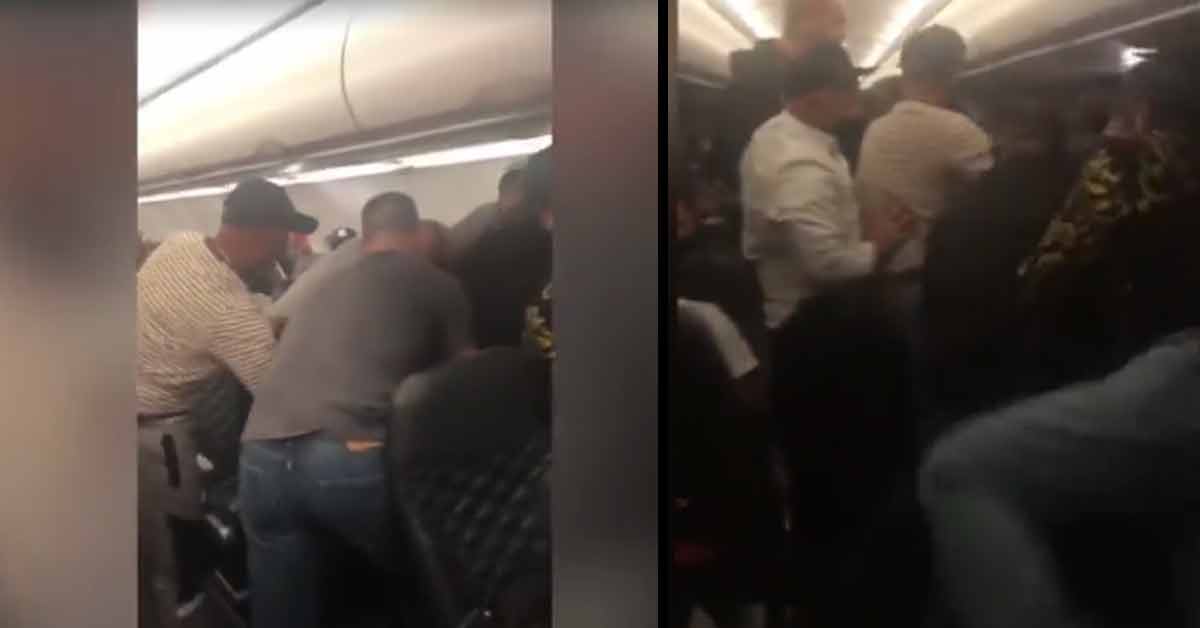 men holding down a passenger on a flight