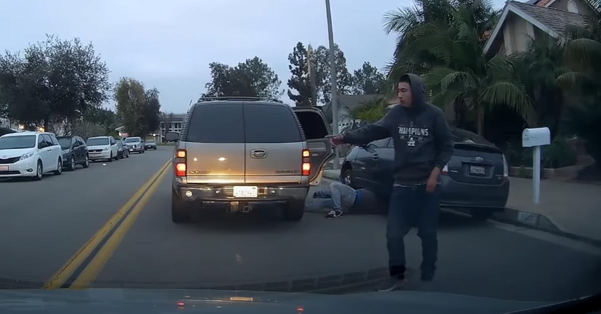 a guy telling a driver to go around while his friend steals a catalytic converter