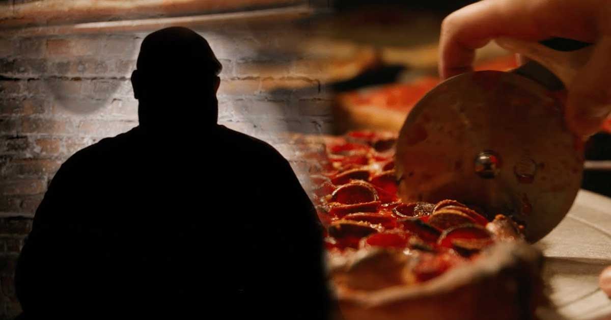 a shadowy figure with a slice of pizza in the background