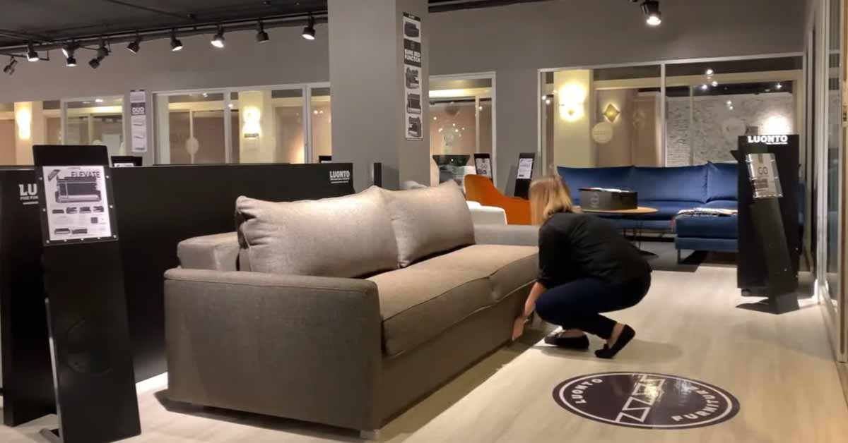 a woman flipping a couch into a bunk bed