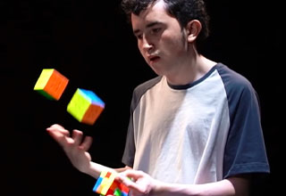 juggler solves rubik's cubes