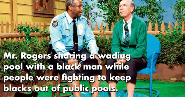 Mr Rodger sitting in a pool with a black man