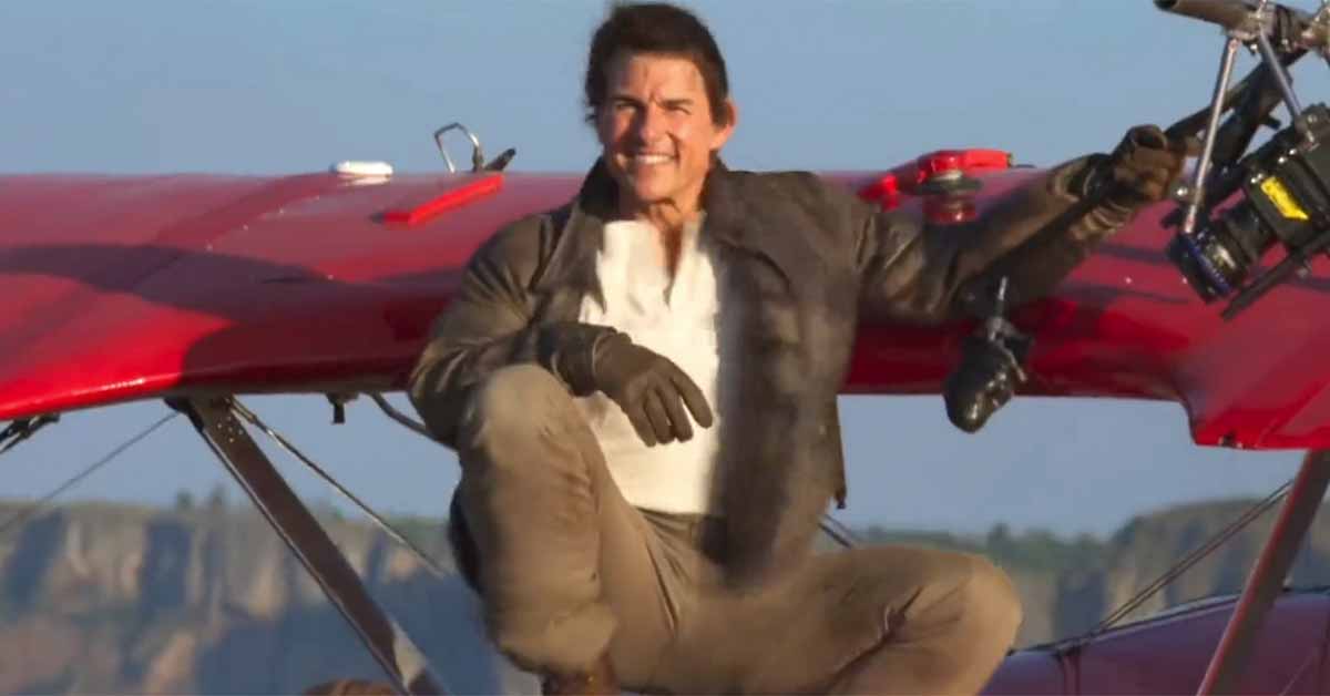 tom cruise on the edge of a plane