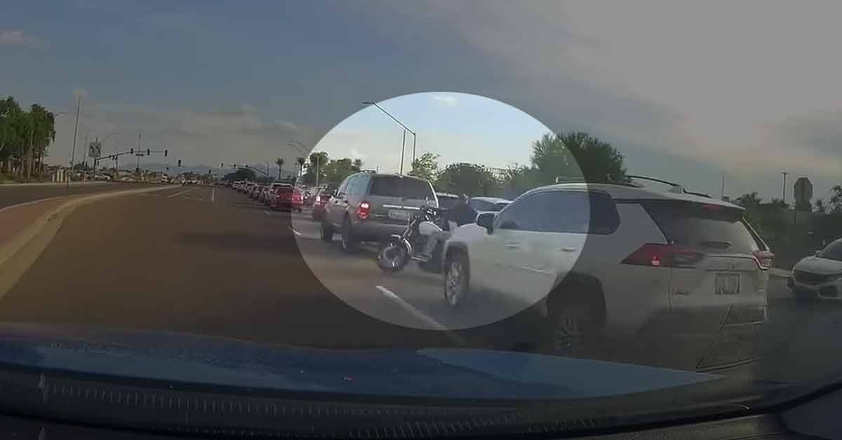 a motorcycle pulling out Infront of a car