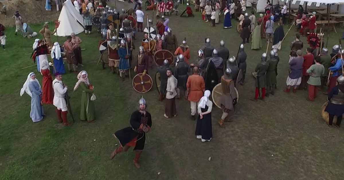 a man dressed as a viking throwing a spear at a drone