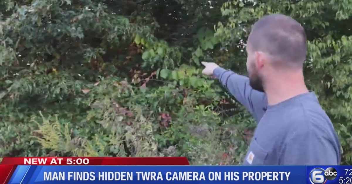 guy pointing at trees where camera was