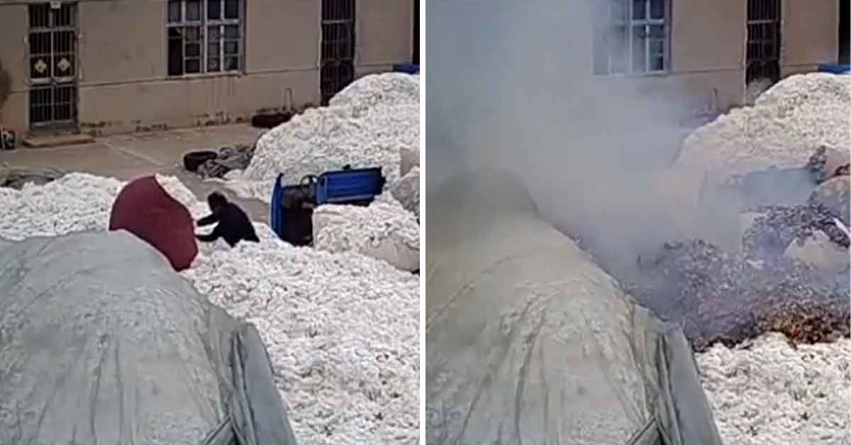 man lights a fire inside a cotton factory