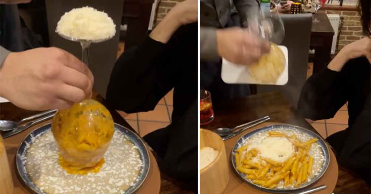 pasta served in a wine glass with a pile of cheese on top