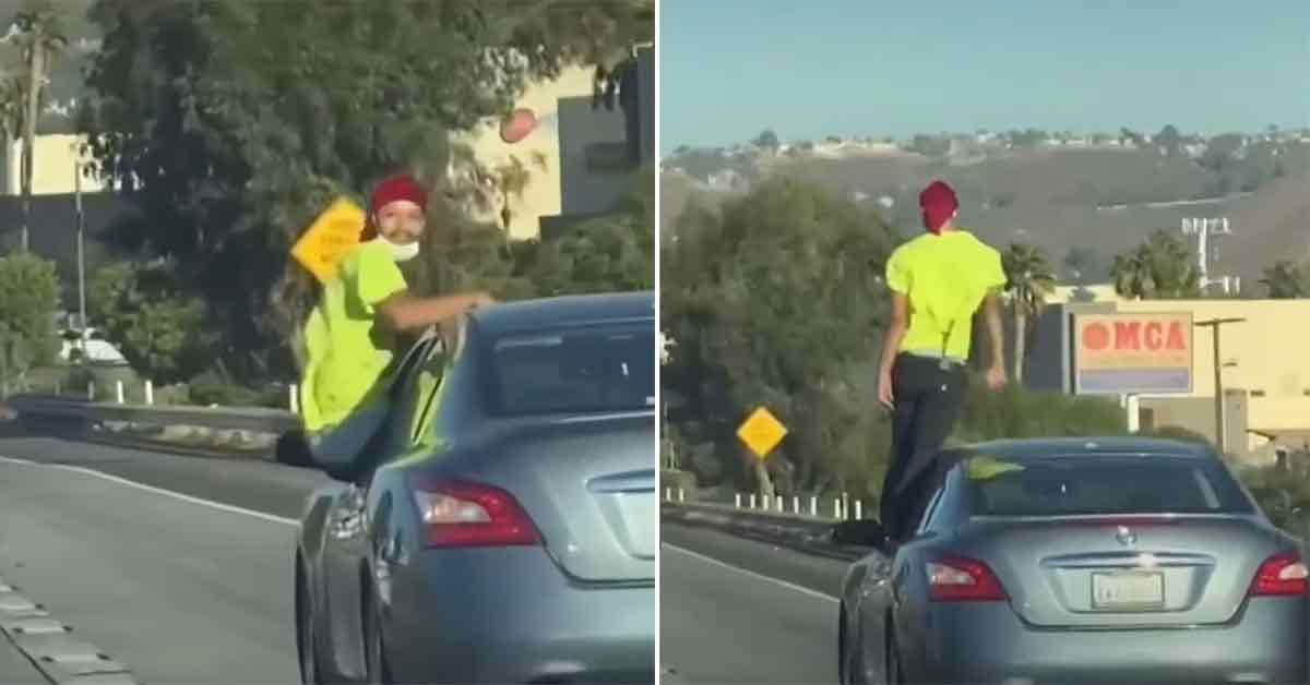 Man Filmed Standing On His Rear View Mirror While Speeding Down the Freeway