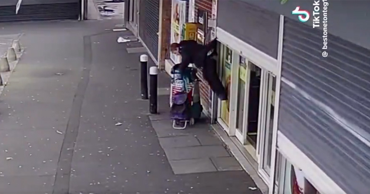 Woman Gets Lifted Off the Ground By Roll-Up Door