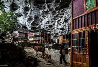 <p>China's last cave village is a tiny isolated community tucked away in Guizhou Province's mountainous region, but despite its small size and extreme poverty, it's not going anywhere.&nbsp;</p><p><br></p><p>Zhongdong only houses 18 families and about 100 people, but the 160-foot high, 750-foot deep cave is not a home many of them are willing to give up.&nbsp;</p><p><br></p><p>Zhongdong was founded in 1949 when the Chinese Civil War drove people out of urban areas in search of safer living. The cave provides shelter from the elements, natural drinking water, and a consistent comfortable living temperature. However, the agrarian society struggles from a difficult farming environment, and a lengthy hike from any form of society.&nbsp;</p><p><br></p><p>Zhongdong is mostly self-sufficient, but the community sits well below the international poverty line, and farmers struggle to sell their goods. In an effort to eradicate poverty, China has repeatedly offered and built Zhongdong residents new homes and farms, but the cave dwellers have repeatedly refused to move. It's their home, and they're not going anywhere.&nbsp;</p><p><br></p><p>You can check out more cool photos and information about Zhongdong in <a href="https://www.goldthread2.com/travel/china-last-cave-village-zhongdong/article/3077132" rel="noopener noreferrer" target="_blank">this Goldthread article</a> and <a href="https://bryandenton.com/china-cave-dwellers/xo2yaw4dznfl7gn76i3bodwo3pnlnp" rel="noopener noreferrer" target="_blank">in Bryan Denton's portfolio</a>.&nbsp;</p>