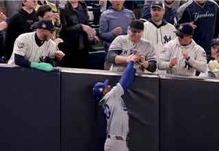 <p>Last night, the New York Yankees looked like they had life for the first time this World Series, thumping the Dodgers in a resounding 11-4 Game 4 victory. But on a night when the stories should have been about the Yankees' exploding bats, instead, everyone is talking about the behavior of two fans.</p><p><br></p><p>In the bottom of the first inning with the game barely underway, Yankee leadoff hitter Glayber Torres skied a foul ball down the right field line. Dodgers' right fielder Mookie Betts leaped towards the stands and made the catch, only for two fans to immediately pry the ball out of his glove.&nbsp;</p><p><br></p><p>The incident instantly brought back memories of the infamous Steve Bartman Cubs incident, except this time, fans overstepped their bounds trying to help their team, instead of hurting it. (And in the age of instant replay, the out was still recorded.)</p><p><br></p><p>Viewers around the country were outraged, calling for the MLB to permanently ban the fans, with some urging assault charges. But Yankee fans were more supportive; this is bedlam in the Bronx.&nbsp;</p><p><br></p><p>Later the fan was identified as Austin Capobianco, and while he understood the consequences of his actions, he was less than sorry. "I patrol that wall and they know that. If it’s in our area, we’re going to ‘D’ up.”</p><p><br></p><p>Capobianco claimed he was informed he would be allowed back for Game 5. Time will tell if he ever sees another Yankee game again.&nbsp;</p>