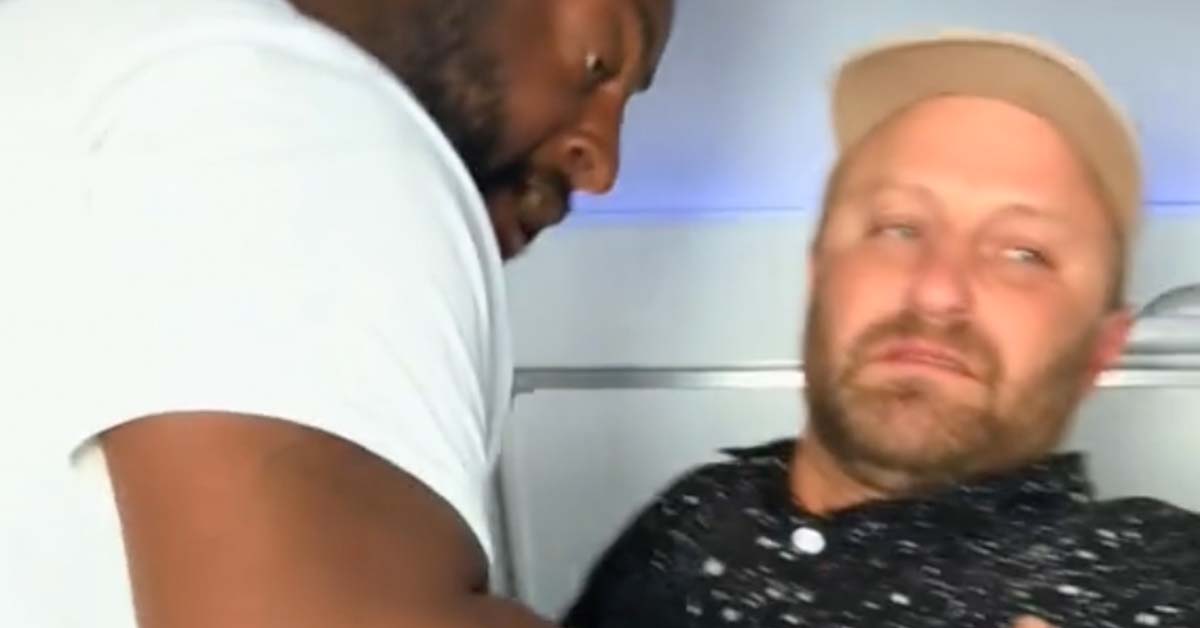 Dude Freaking Out on Airplane Gets Manhandled Back Into His Seat